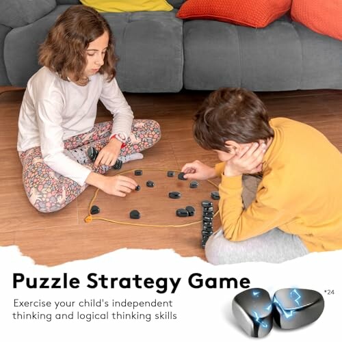 Two children playing a puzzle strategy game on the floor.