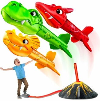 Child playing with dinosaur-themed rocket launcher toy.