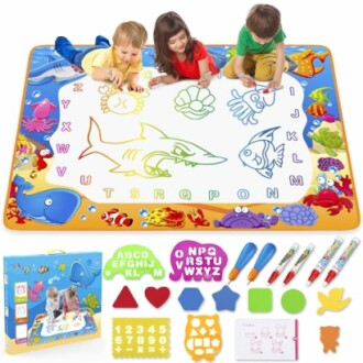 Children drawing on an educational water mat with letters and ocean animals.