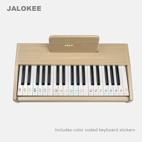 Wooden kids piano keyboard with color-coded stickers.